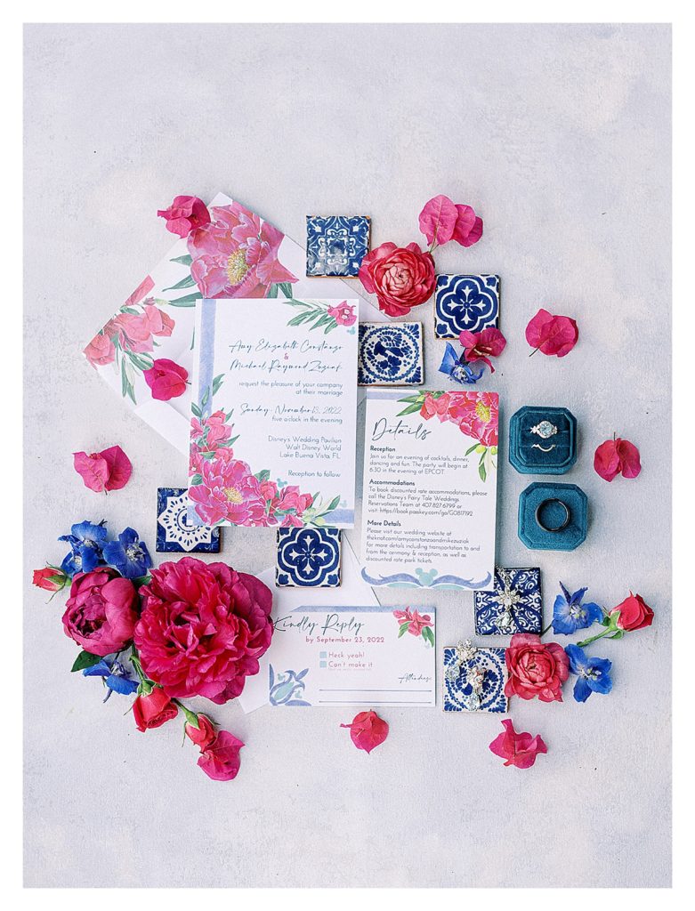 magenta and blue floral wedding invitation flat lay styled with peonies 