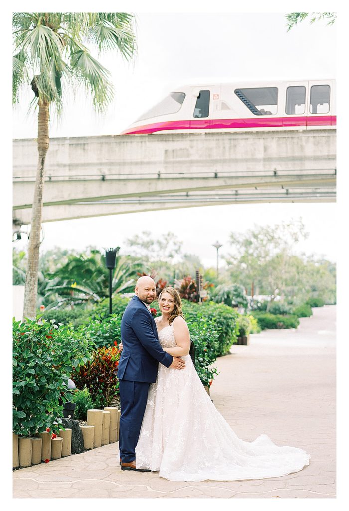 bride and groom with the Disney monorail