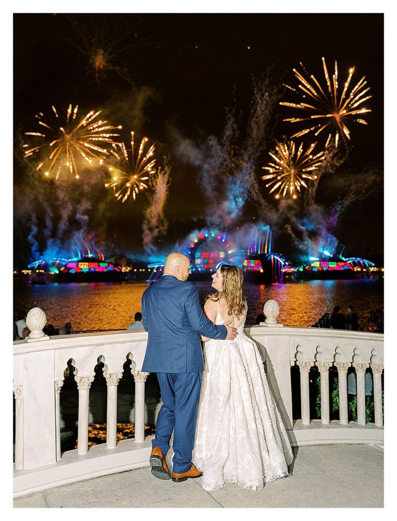 bride and groom candid laugh in front of the Epcot fireworks at their Disney wedding